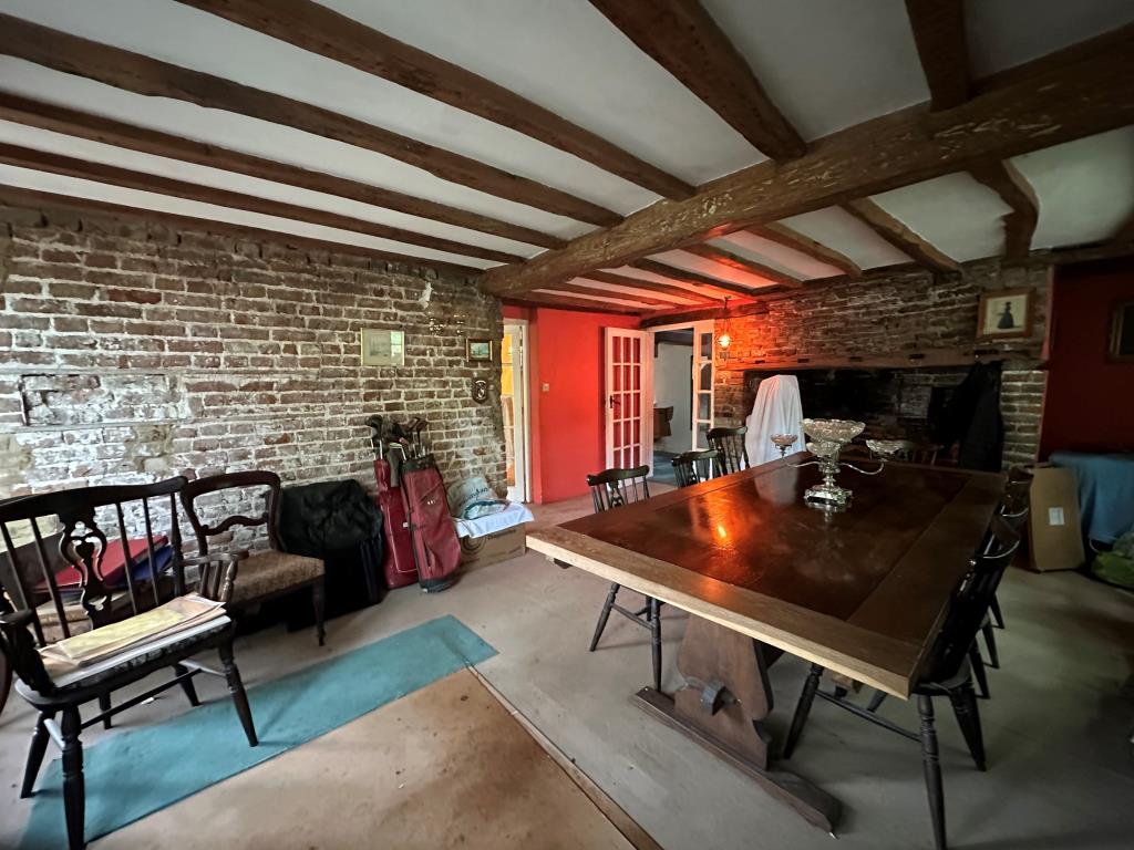 Lot: 107 - DETACHED PROPERTY IN GROUNDS OF 3.5 ACRES WITH OUTBUILDINGS, STABLES AND DILAPIDATED BARN - Dining room with fireplace